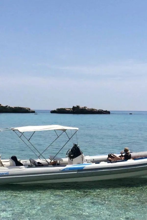 Coastal views and boat rentals near Gavdos island, showing clear waters and the Mediterranean coastline of Crete.